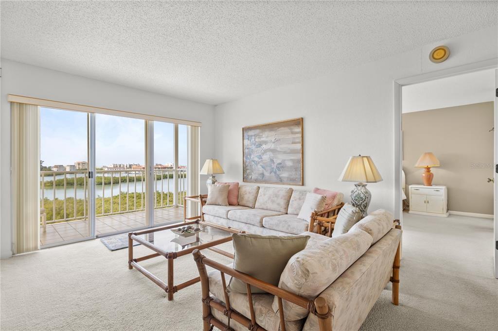 9000 Commodore Drive, Unit 604 Seminole, FL 33776 - Photo 18 of 50 a living room with furniture and a large window