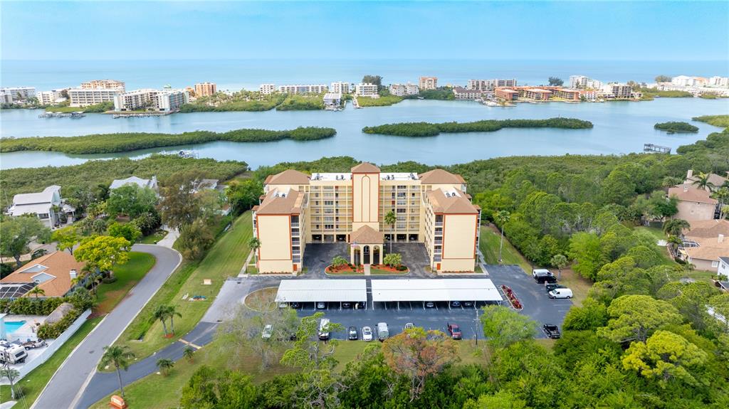 9000 Commodore Drive, Unit 604 Seminole, FL 33776 - Photo 2 of 50 an aerial view of a city with lots of residential buildings lake and ocean view