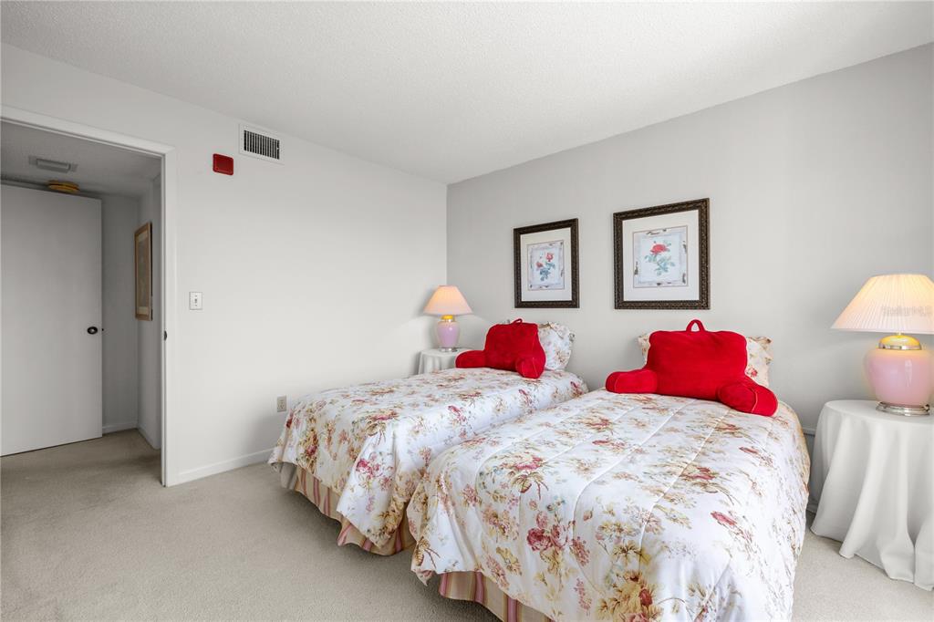 9000 Commodore Drive, Unit 604 Seminole, FL 33776 - Photo 22 of 50 a bedroom with two bed and a closet