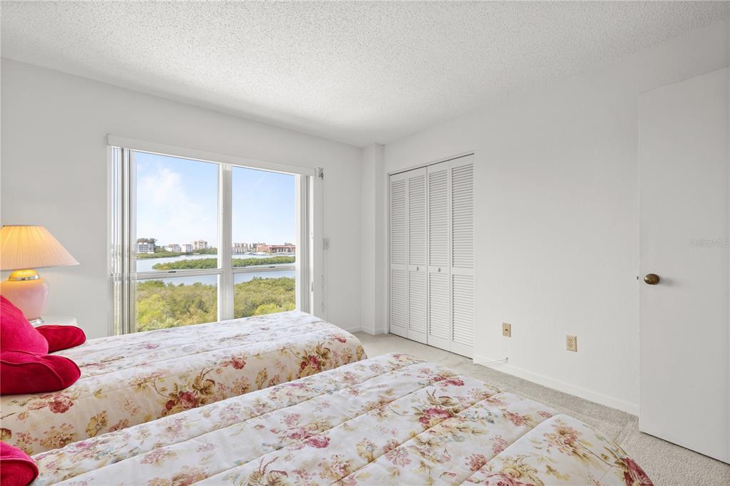 9000 Commodore Drive, Unit 604 Seminole, FL 33776 - Photo 23 of 50 a bedroom with a bed and a window