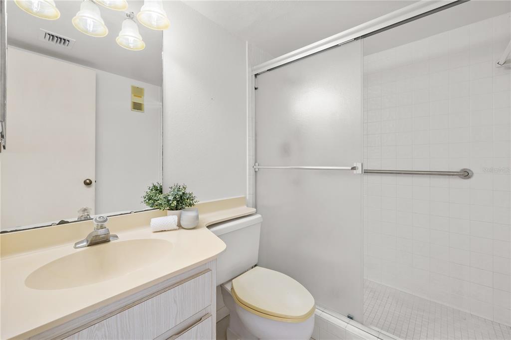 9000 Commodore Drive, Unit 604 Seminole, FL 33776 - Photo 24 of 50 a bathroom with a sink toilet and shower