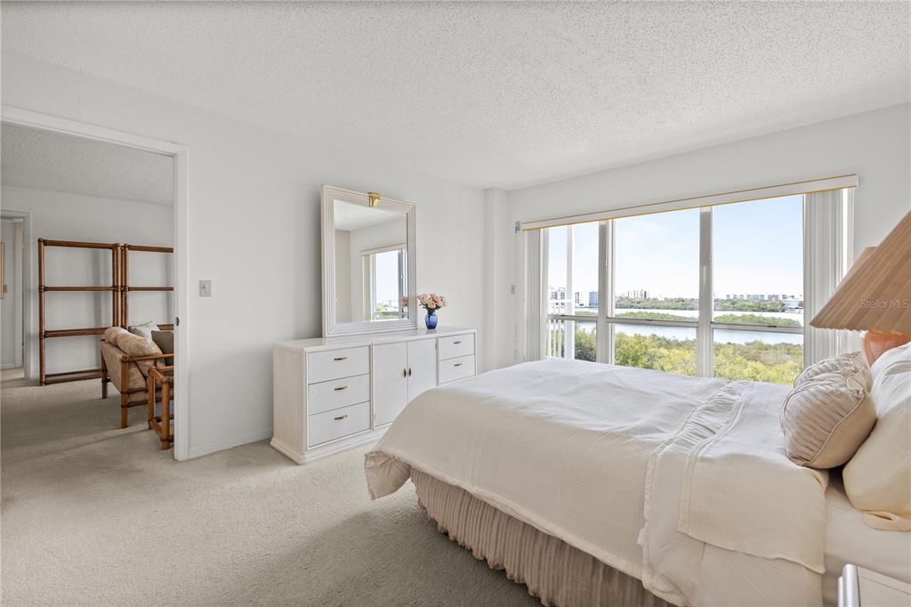 9000 Commodore Drive, Unit 604 Seminole, FL 33776 - Photo 25 of 50 a spacious bedroom with a bed and a large window