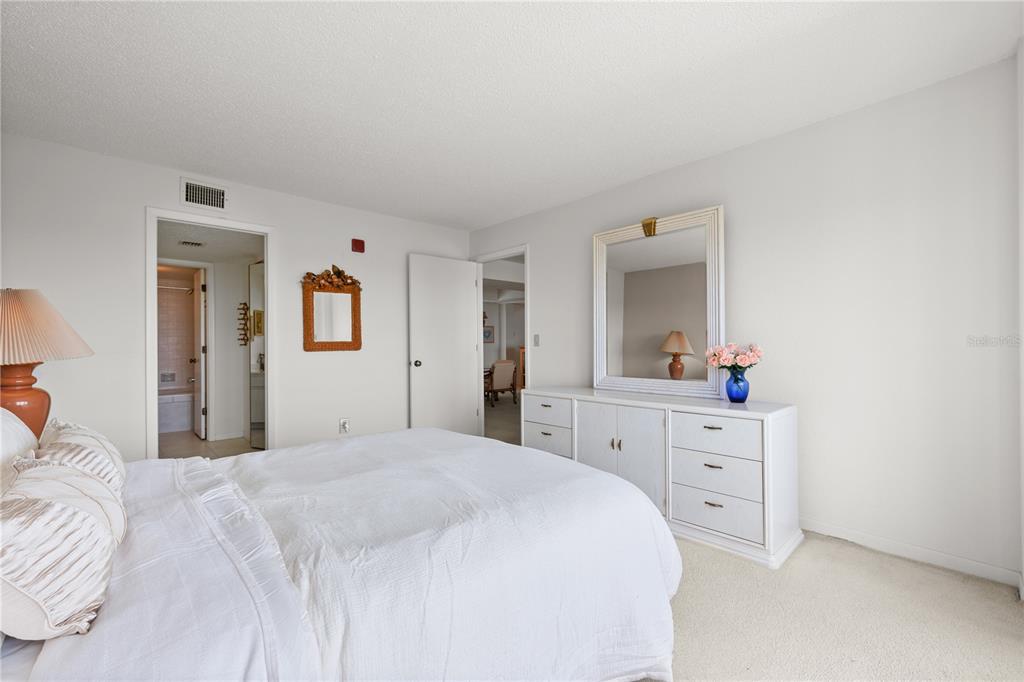 9000 Commodore Drive, Unit 604 Seminole, FL 33776 - Photo 27 of 50 a bedroom with a bed and a dresser