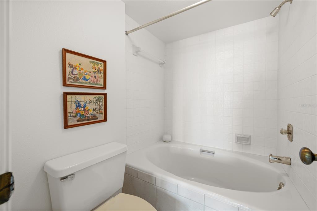 9000 Commodore Drive, Unit 604 Seminole, FL 33776 - Photo 30 of 50 a bathroom with a toilet and a bathtub
