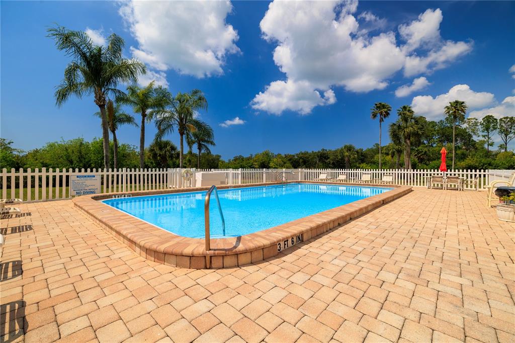 9000 Commodore Drive, Unit 604 Seminole, FL 33776 - Photo 3 of 50 a view of a swimming pool with a bench
