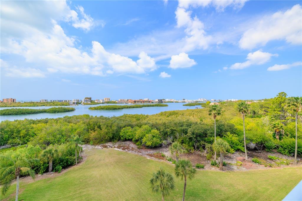 9000 Commodore Drive, Unit 604 Seminole, FL 33776 - Photo 33 of 50 a view of a lake with a beach
