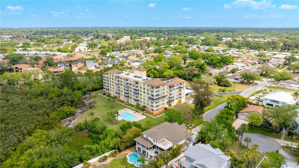9000 Commodore Drive, Unit 604 Seminole, FL 33776 - Photo 37 of 50 an aerial view of residential building with outdoor space and trees
