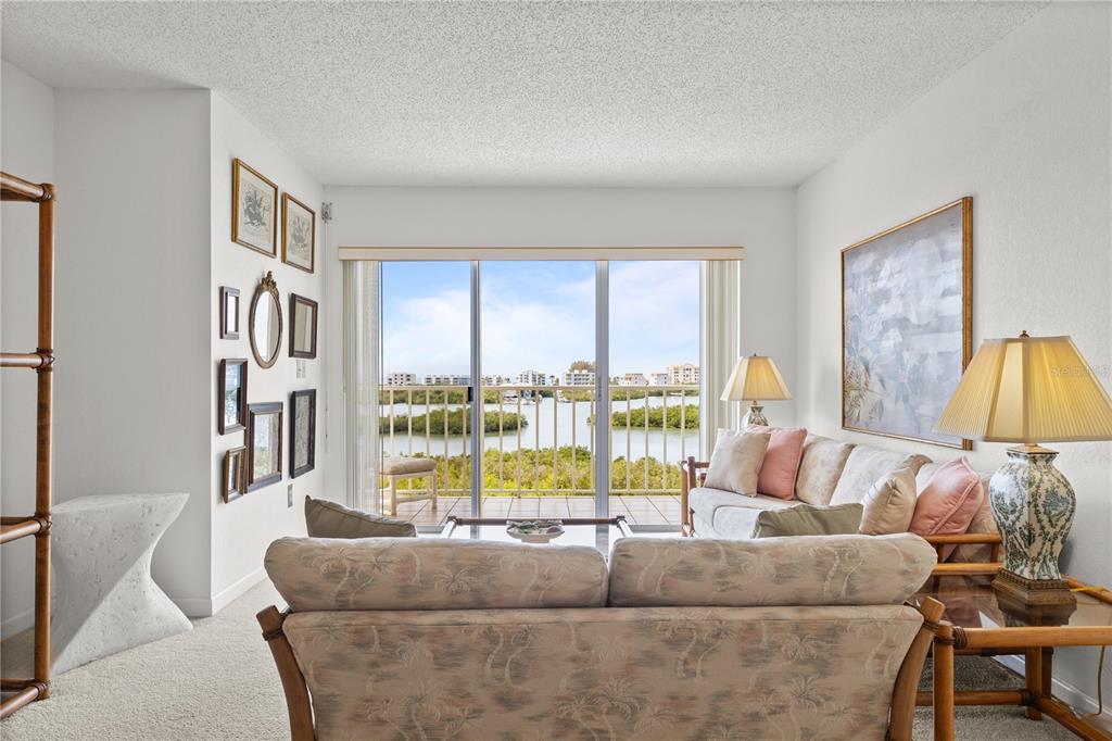 9000 Commodore Drive, Unit 604 Seminole, FL 33776 - Photo 4 of 50 a living room with furniture and a large window