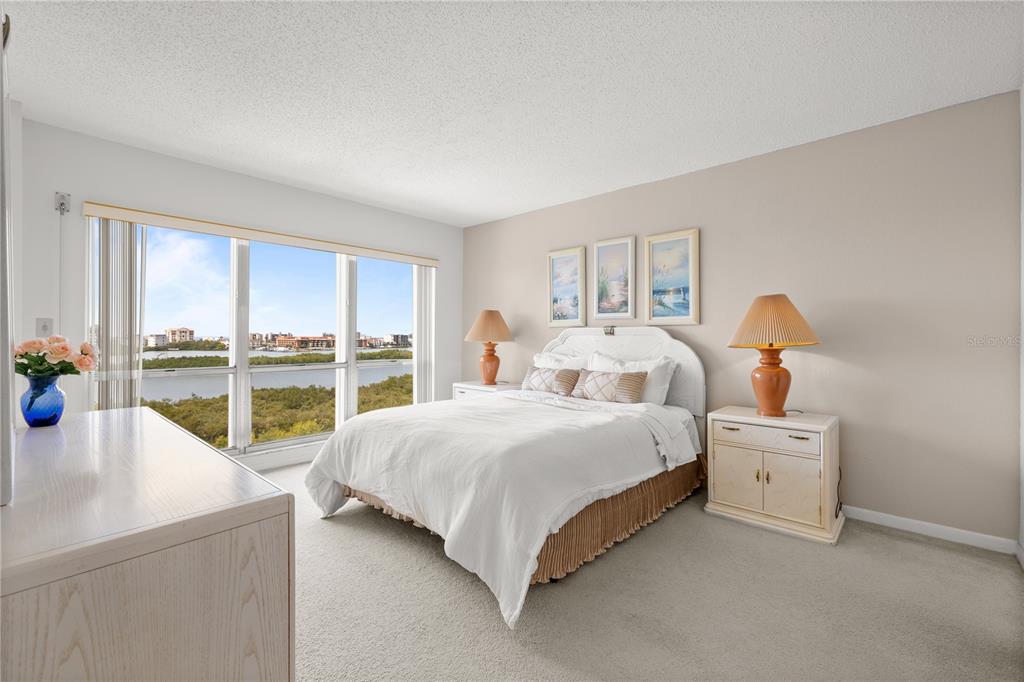 9000 Commodore Drive, Unit 604 Seminole, FL 33776 - Photo 6 of 50 a bedroom with a bed and a large window