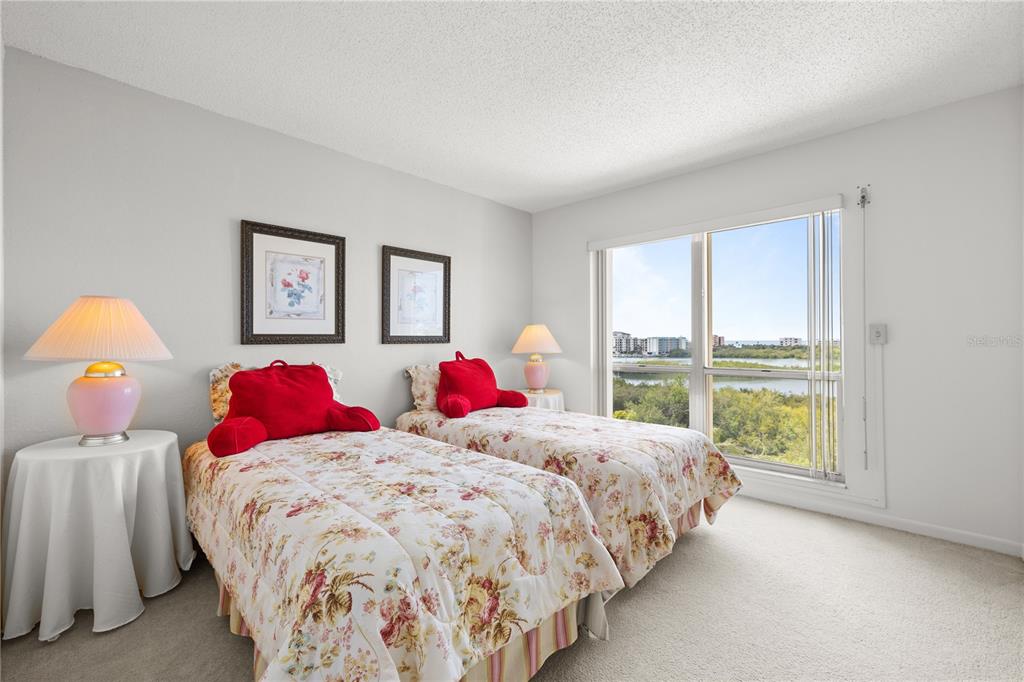 9000 Commodore Drive, Unit 604 Seminole, FL 33776 - Photo 7 of 50 a bedroom with a large bed and a window