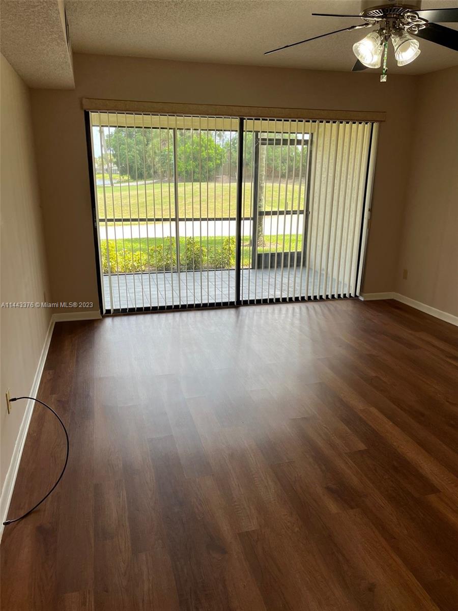 a view of a room with wooden floor and windows