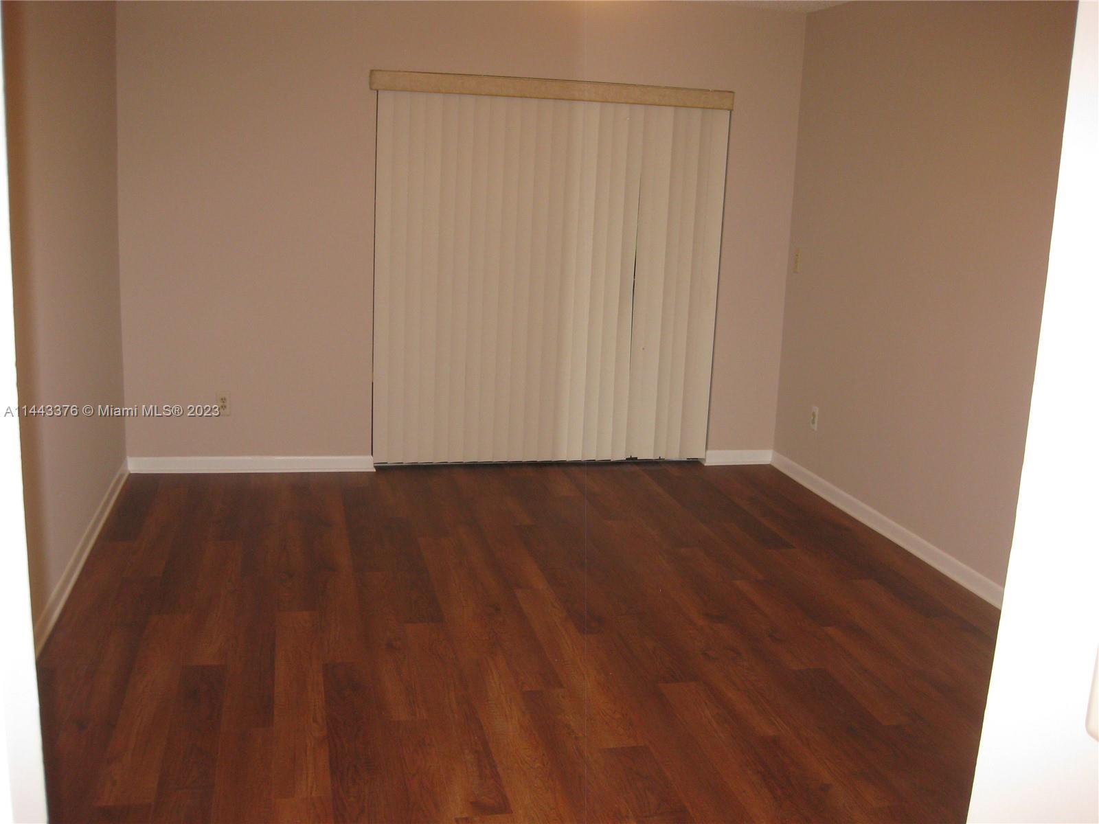 801 Pinecrest Circle, Unit E Jupiter, FL 33458 - Photo 11 of 18 a view of wooden floor and brick wall