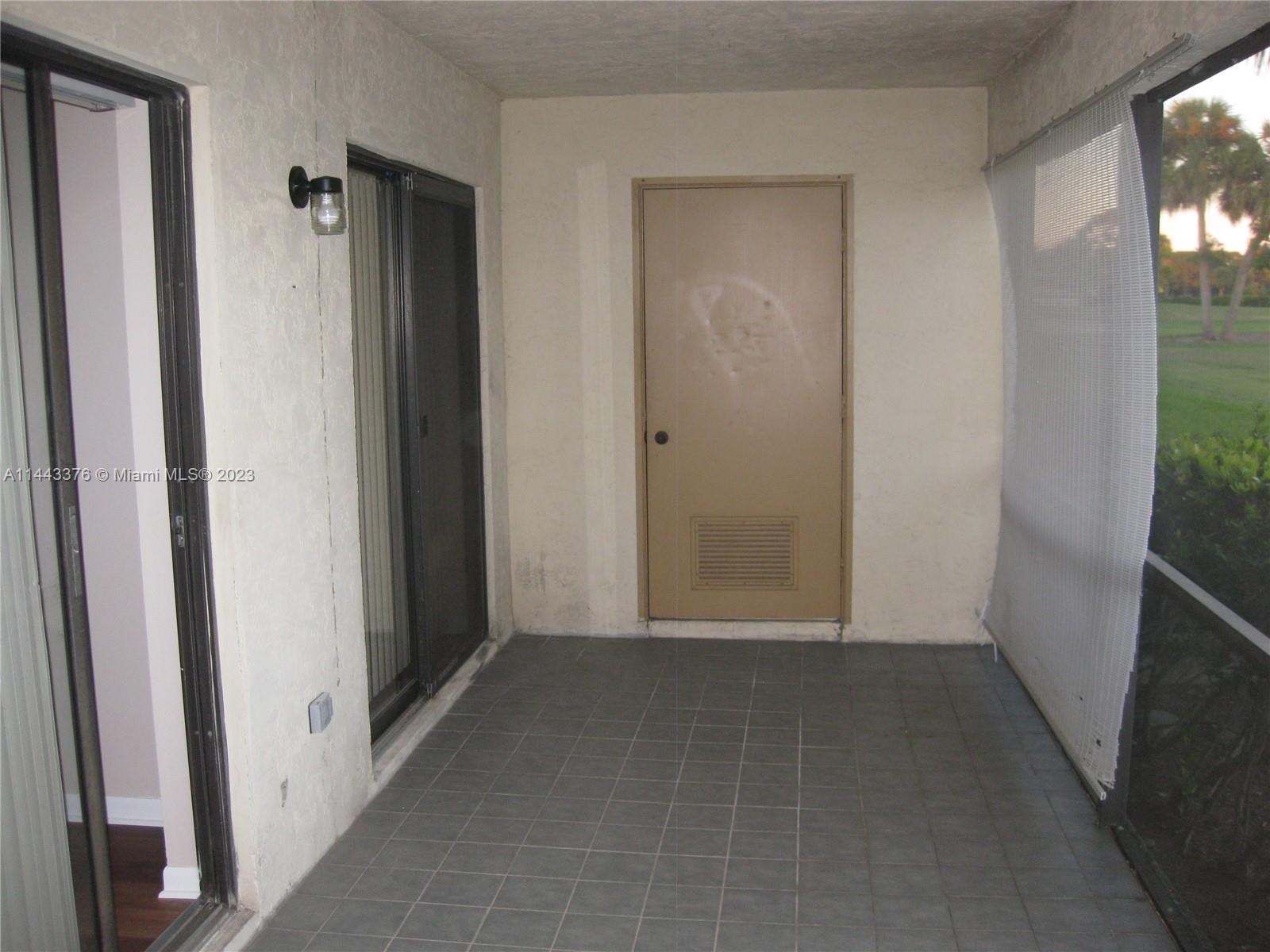 801 Pinecrest Circle, Unit E Jupiter, FL 33458 - Photo 14 of 18 a view of a hallway with wooden floor and a living room
