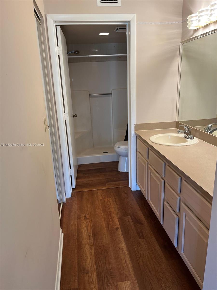 801 Pinecrest Circle, Unit E Jupiter, FL 33458 - Photo 4 of 18 a bathroom with a sink and a mirror