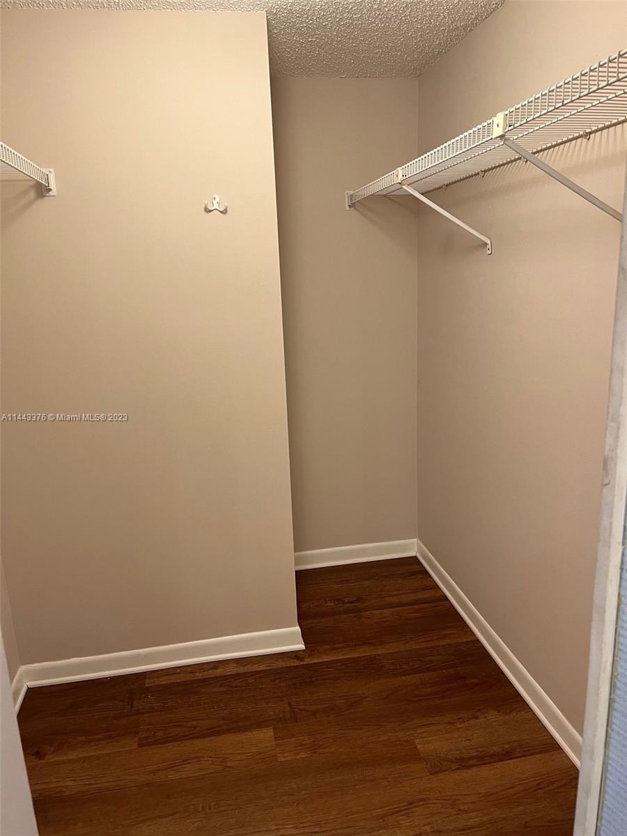 801 Pinecrest Circle, Unit E Jupiter, FL 33458 - Photo 5 of 18 a view of a small space with wooden floor and a window