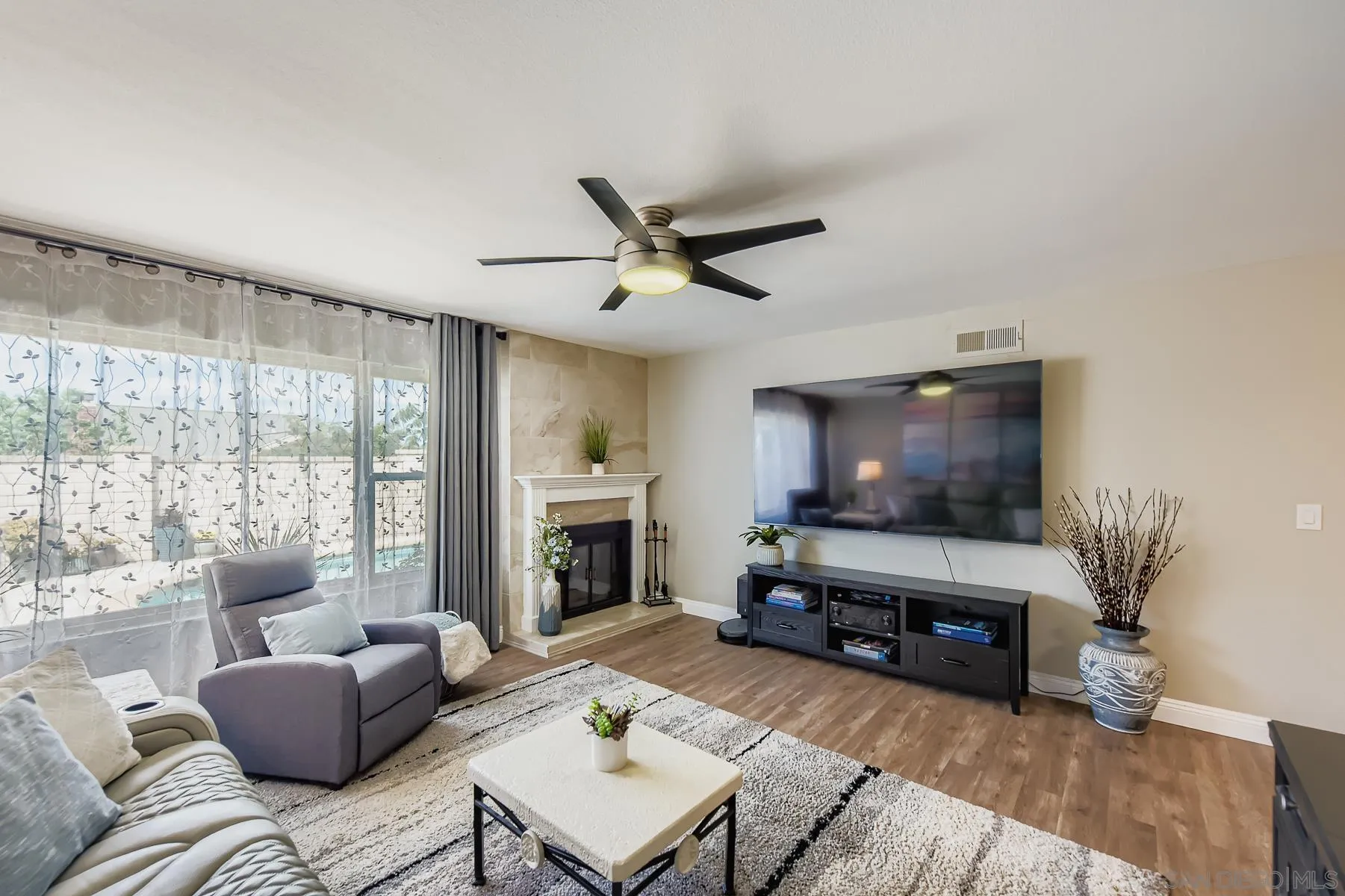 12450 Robison Boulevard Poway, CA 92064 - Photo 12 of 32 a living room with furniture a flat screen tv and a large window