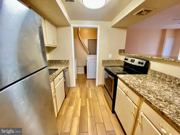 a kitchen with a stove top oven and sink