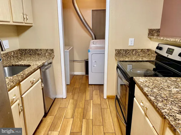 a kitchen with a sink stove and refrigerator