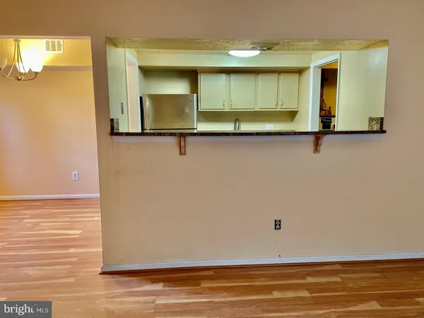 a view of a room with wooden floor