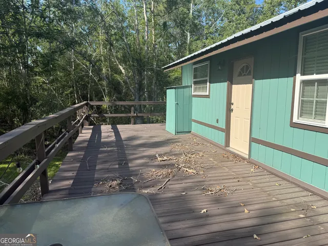 a view of backyard with deck and outdoor seating