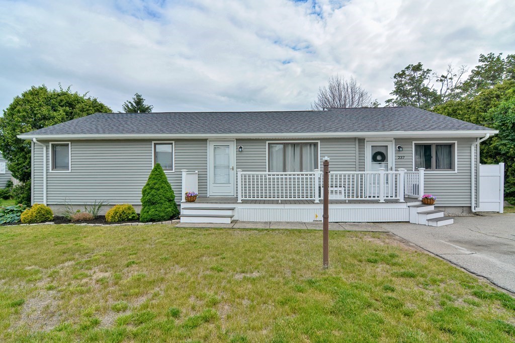 237 Kaufman Road Somerset, MA 02726 - Photo 1 of 38 a front view of a house with a yard and garage
