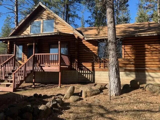a view of a house with a wooden fence