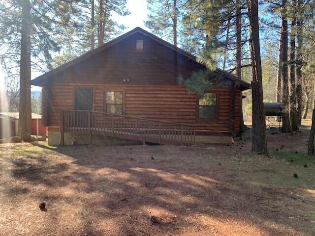 20394 Camas Road Burney, CA 96013 - Photo 46 of 56 a view of a wooden house with a large tree