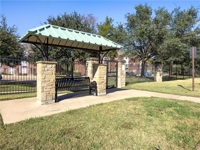 a view of a patio with a table and chairs under an umbrella