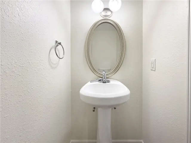 a bathroom with a sink a mirror and vanity