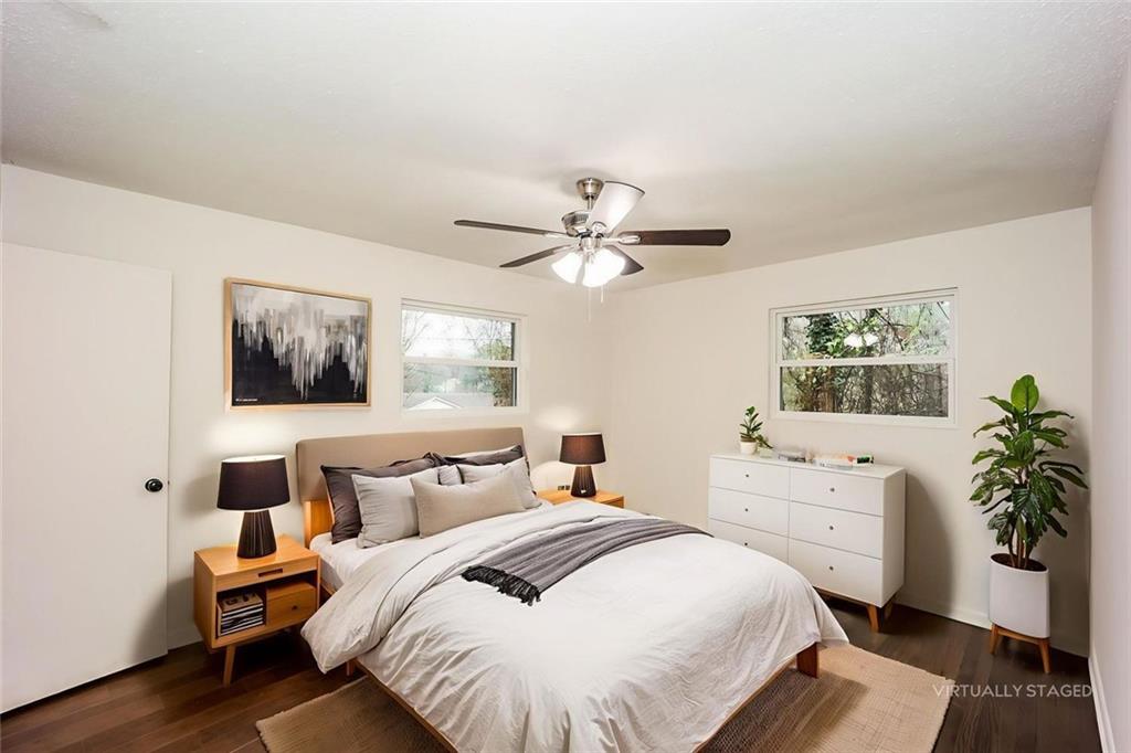 5726 Southwick Court Southwest Atlanta, GA 30349 - Photo 18 of 32 a bedroom with a large bed and a chandelier