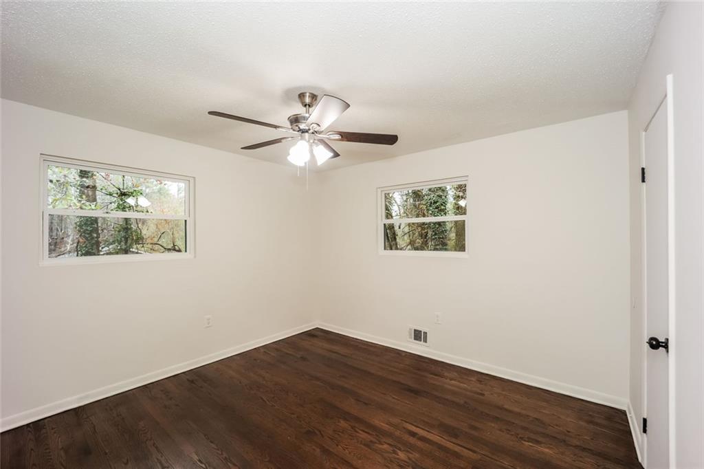 5726 Southwick Court Southwest Atlanta, GA 30349 - Photo 23 of 31 a view of an empty room with wooden floor and a window