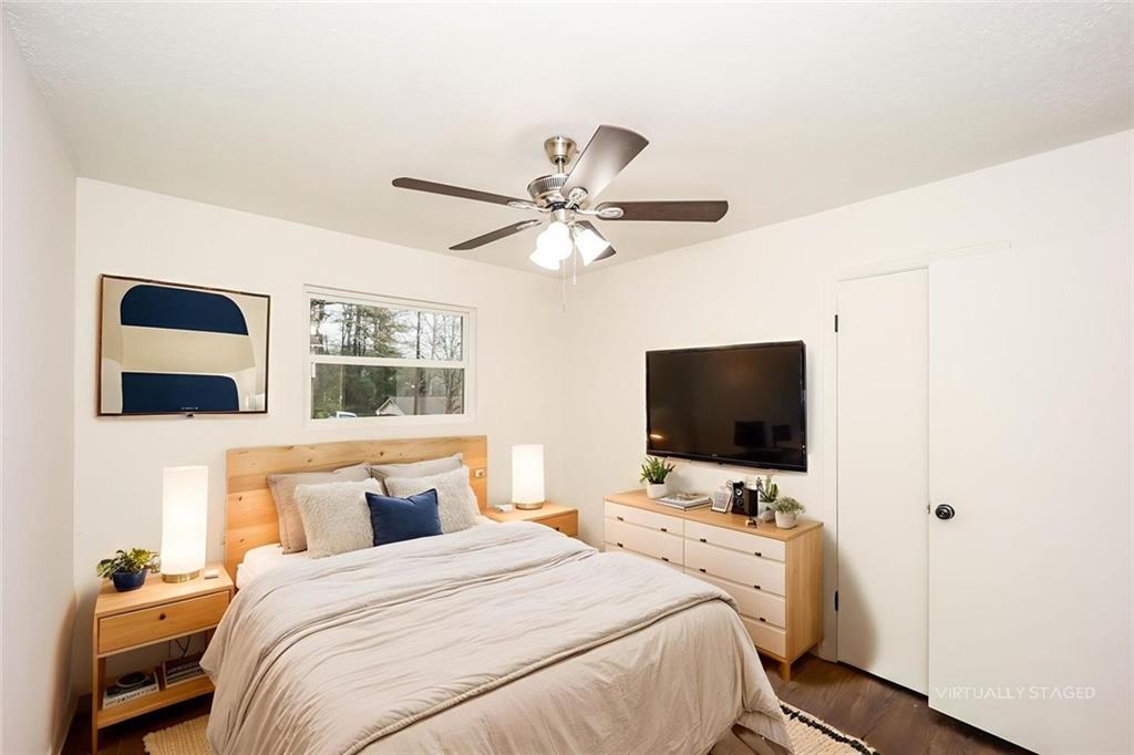 5726 Southwick Court Southwest Atlanta, GA 30349 - Photo 27 of 31 a bedroom with a bed and a flat screen tv