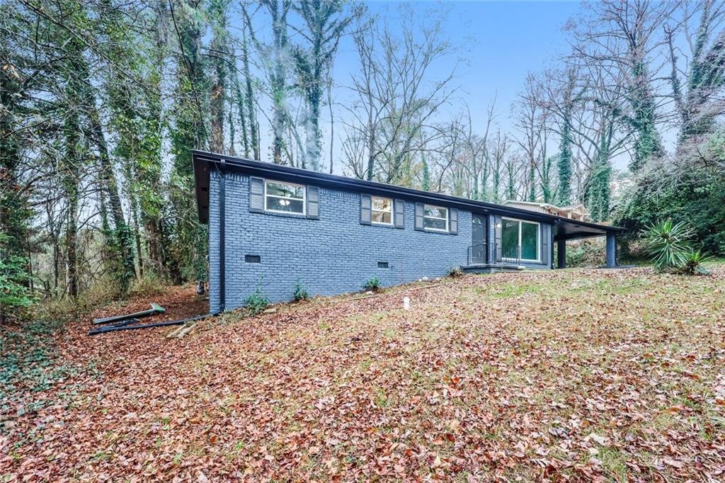 5726 Southwick Court Southwest Atlanta, GA 30349 - Photo 31 of 31 a view of a house with a large tree