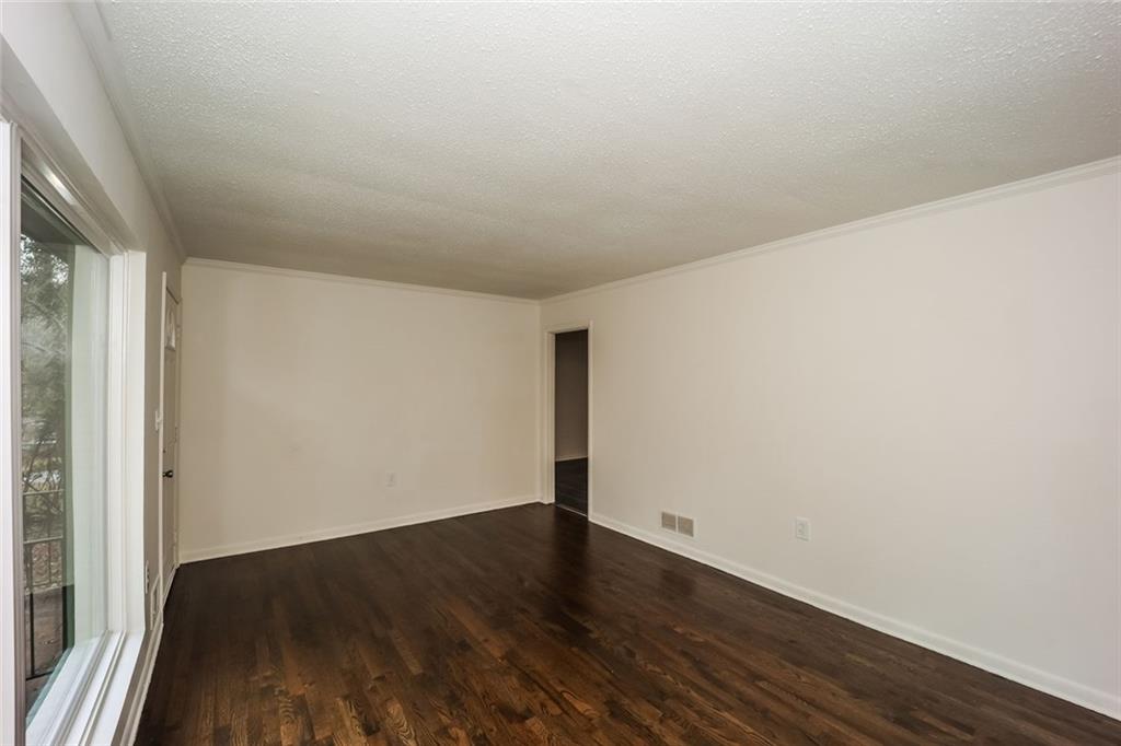 5726 Southwick Court Southwest Atlanta, GA 30349 - Photo 8 of 31 a view of wooden floor and brick walls