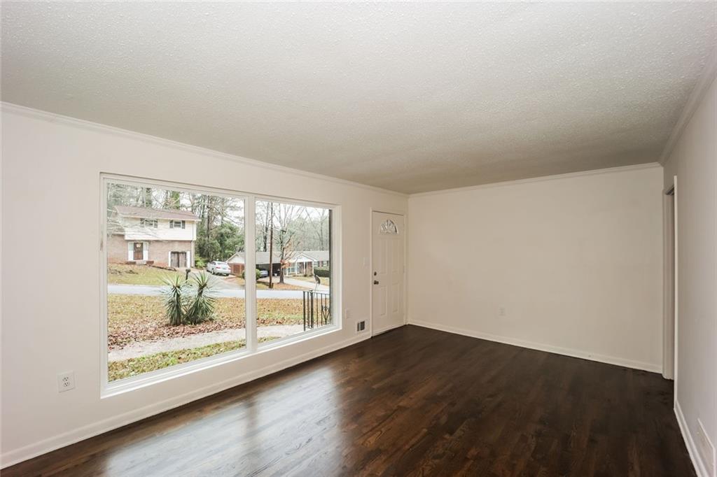 5726 Southwick Court Southwest Atlanta, GA 30349 - Photo 9 of 32 wooden floor in an empty room