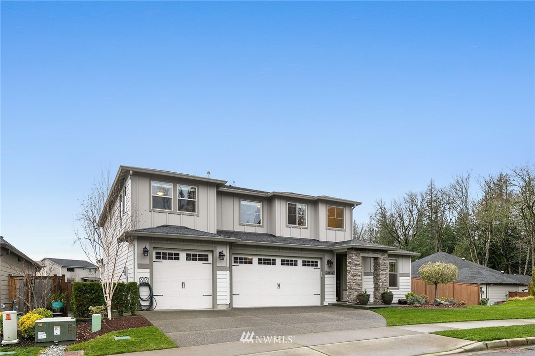 a front view of a house with a yard and garage