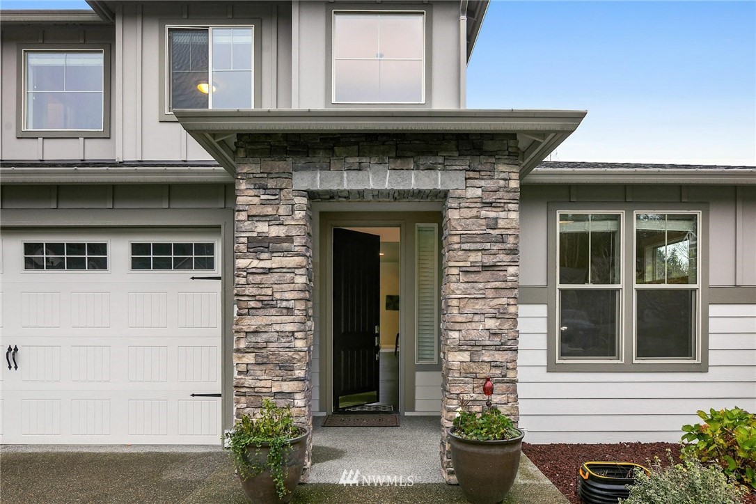 25619 209th Loop Southeast Covington, WA 98042 - Photo 3 of 37 a front view of a house with potted plants
