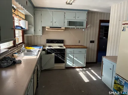 a kitchen with a sink and a stove top oven