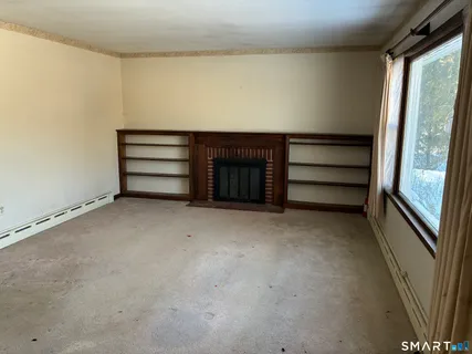 a view of an empty room with a fireplace
