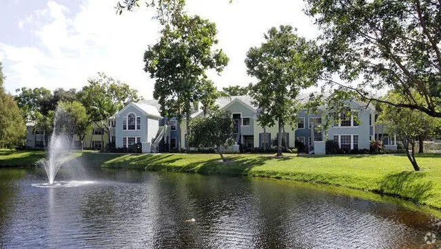 a view of a house with swimming pool next to a yard