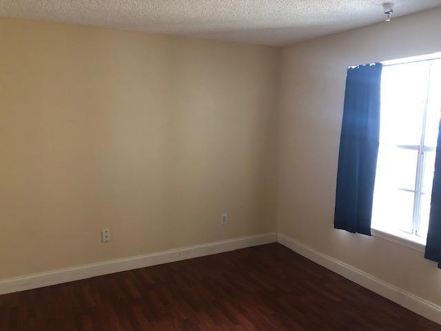 1000 Crystal Way, Unit C Delray Beach, FL 33444 - Photo 5 of 10 a view of a small space with wooden floor and a window