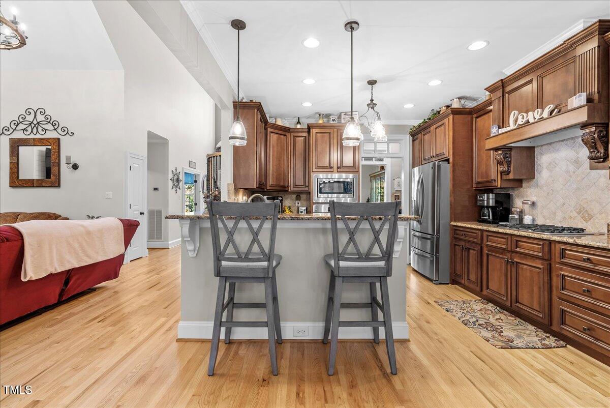 105 Jackson Road Youngsville, NC 27596 - Photo 12 of 55 a dining room with stainless steel appliances granite countertop furniture wooden floor and a rug