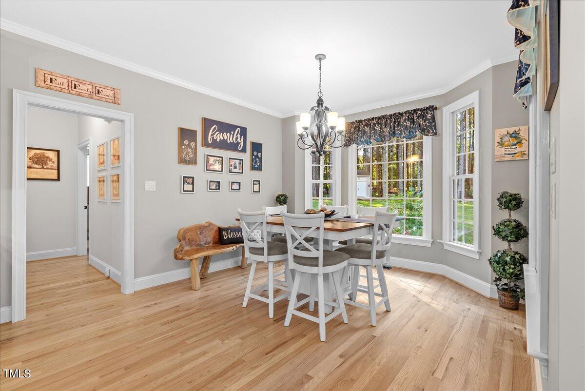 105 Jackson Road Youngsville, NC 27596 - Photo 13 of 55 a view of a dining room with furniture window and wooden floor