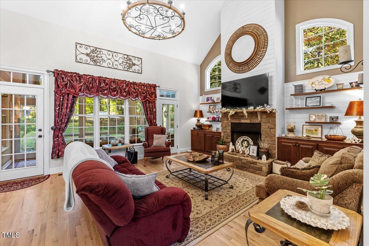 105 Jackson Road Youngsville, NC 27596 - Photo 15 of 55 a living room with furniture a fireplace and a large window