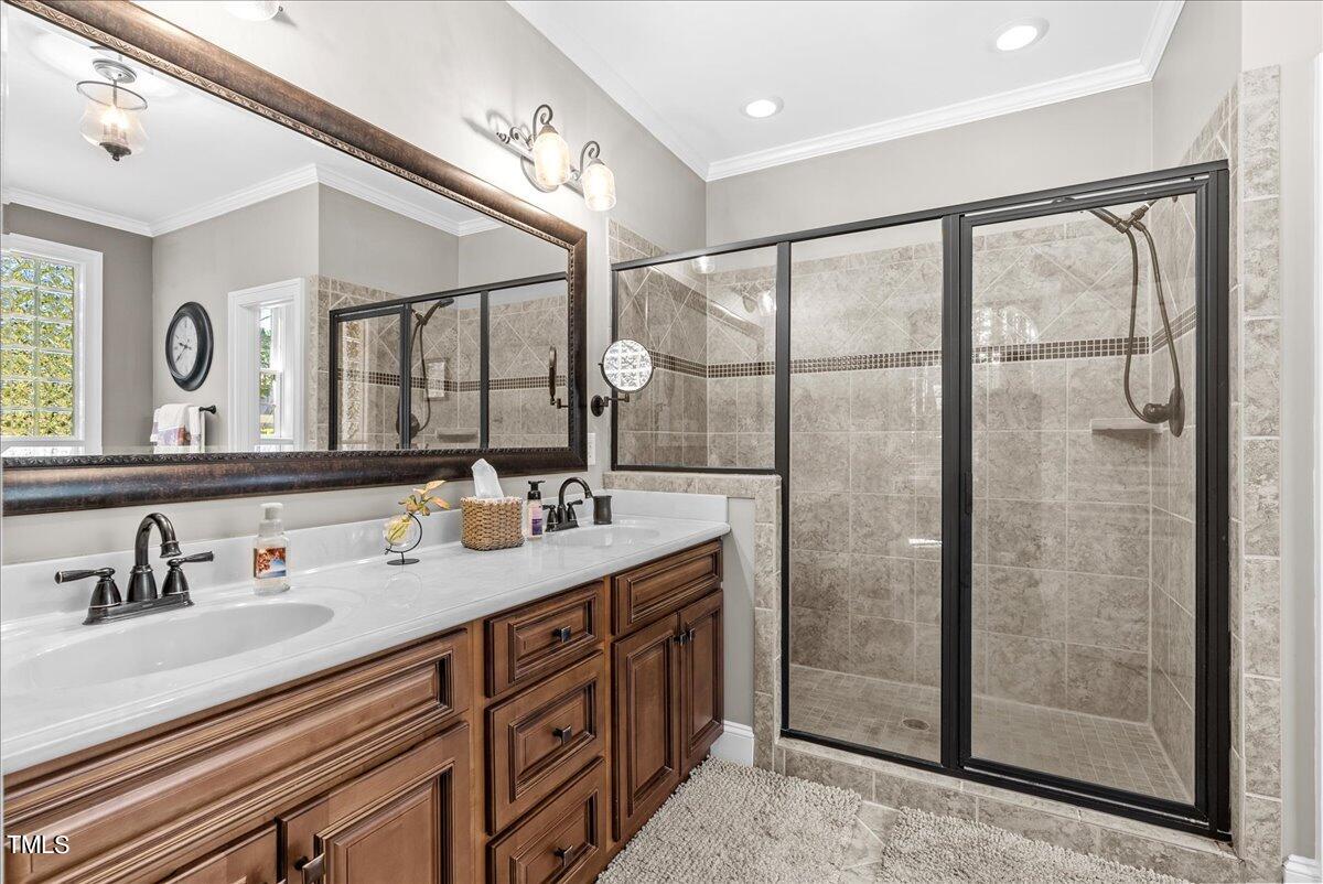 105 Jackson Road Youngsville, NC 27596 - Photo 23 of 55 a bathroom with a double vanity sink mirror and shower