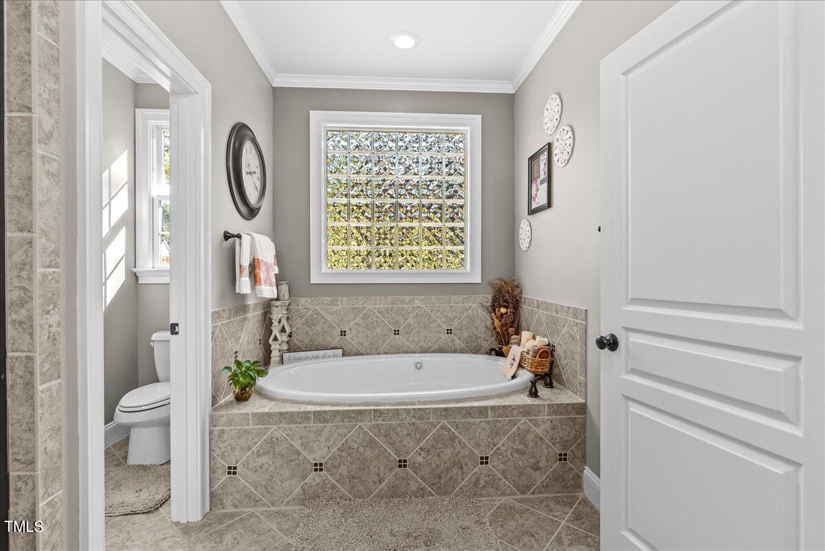 105 Jackson Road Youngsville, NC 27596 - Photo 26 of 55 a spacious bathroom with a bathtub and a shower