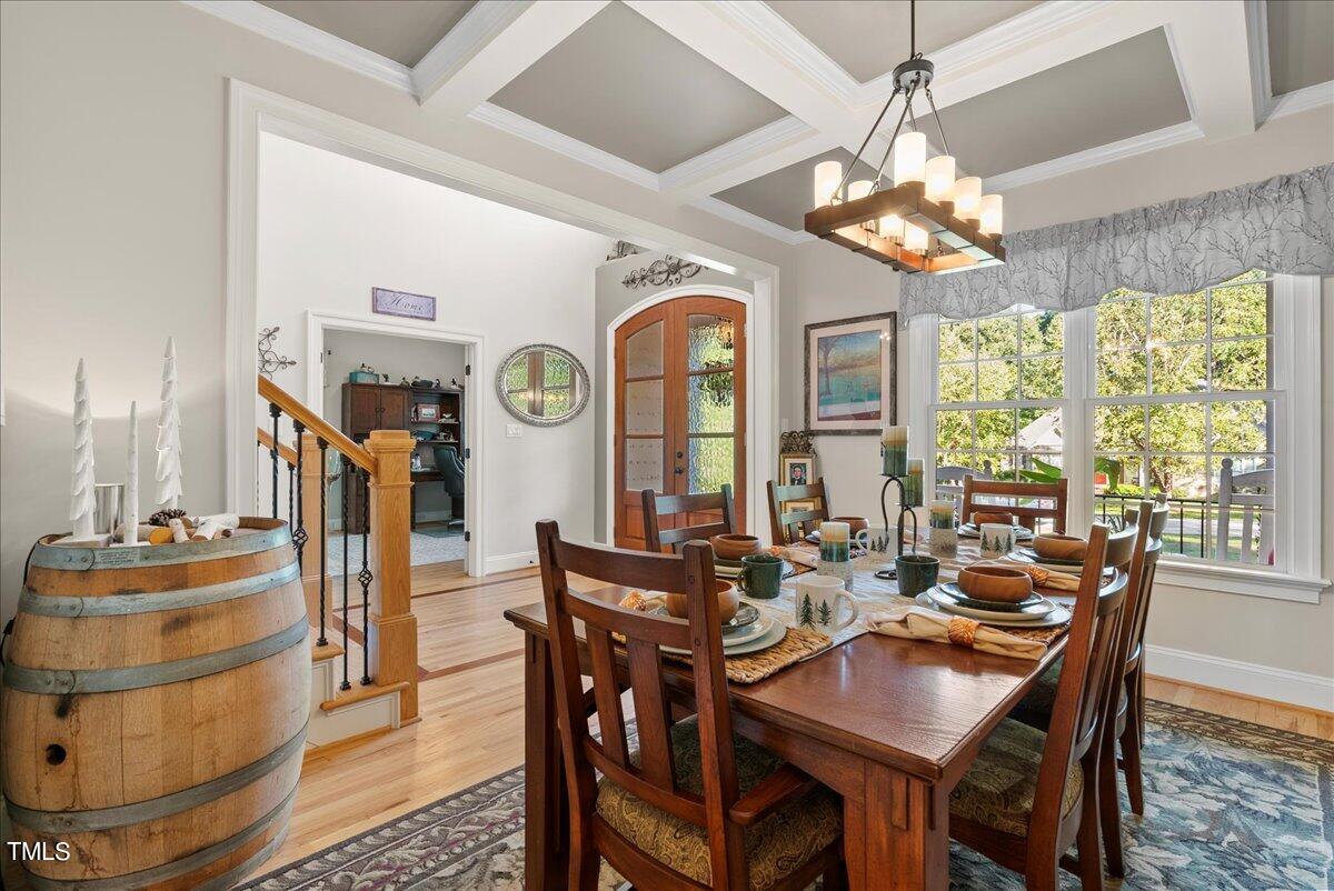 105 Jackson Road Youngsville, NC 27596 - Photo 29 of 55 a view of a dining room with furniture a chandelier and large windows
