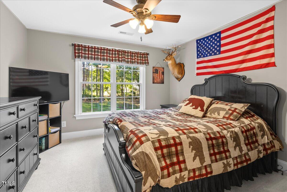 105 Jackson Road Youngsville, NC 27596 - Photo 36 of 55 a bedroom with a bed and a flat screen tv