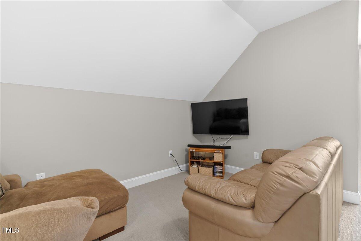105 Jackson Road Youngsville, NC 27596 - Photo 39 of 55 a living room with furniture and a flat screen tv