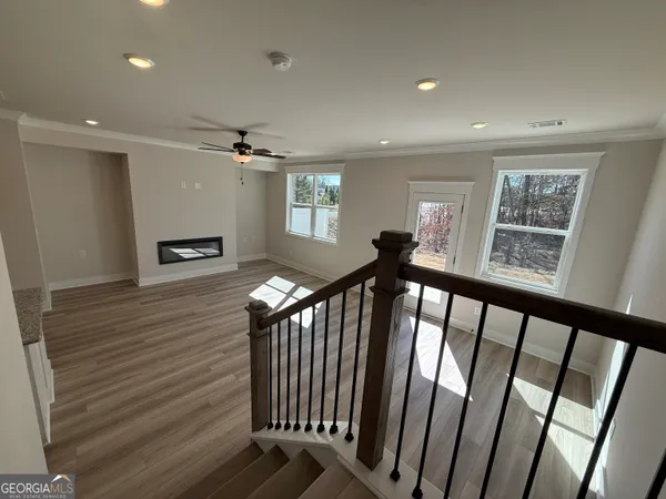a view of a hallway with windows and stairs